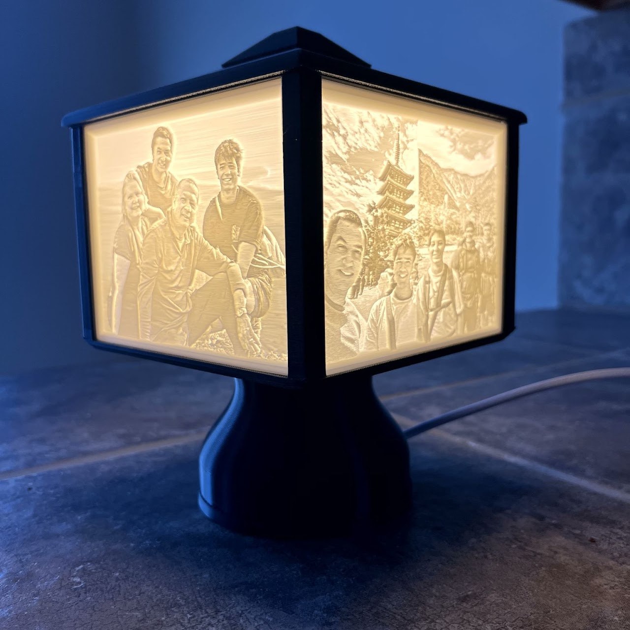 3D-printed lithophane lamp glowing with etched family photos